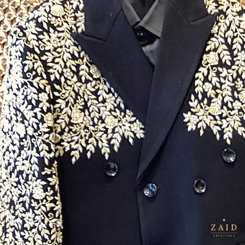 Close-up of silver zardozi leaves on a black double-breasted jacket